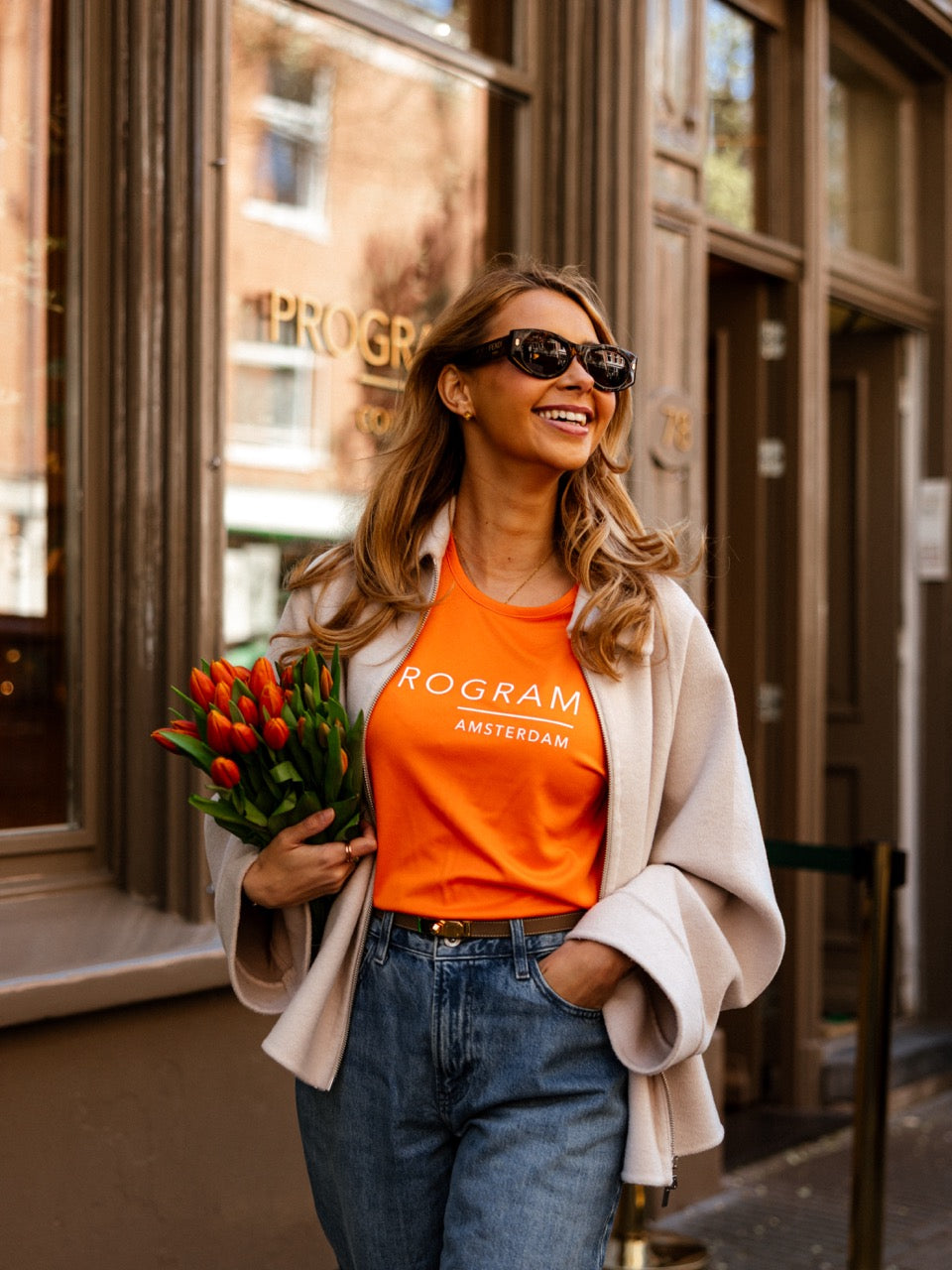 Girl wearing orange program t-shirt with tulips